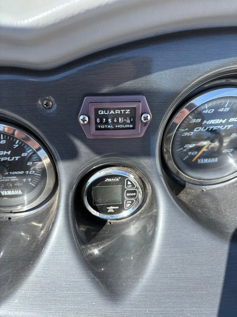 Slide: The Image of Dashboard of 2005 Yamaha Boats 230 SX showing gauges and hour meter. - 10