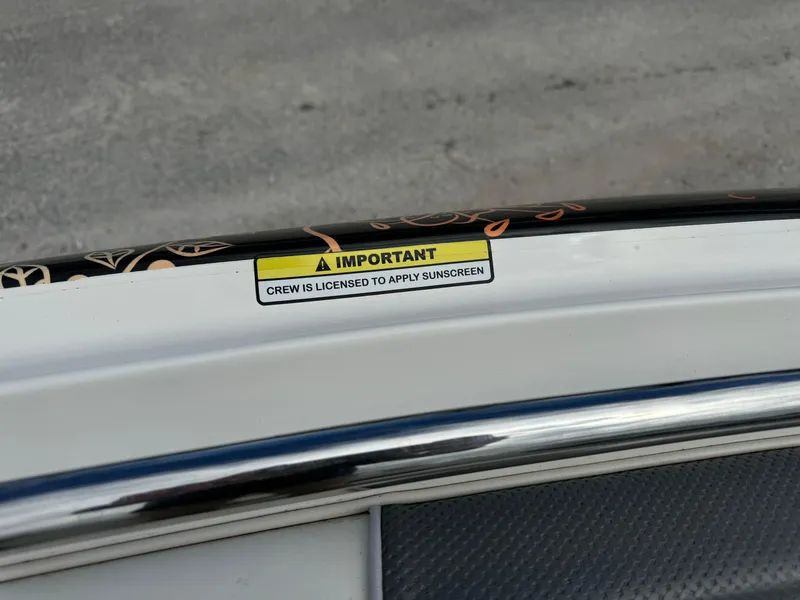 Slide: The Image of 2005 Yamaha Boats 230 SX with humorous sunscreen warning label. - 14