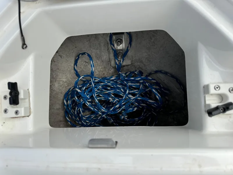 Slide: The Image of Storage compartment with blue rope in a 2005 Yamaha Boats 230 SX. - 15