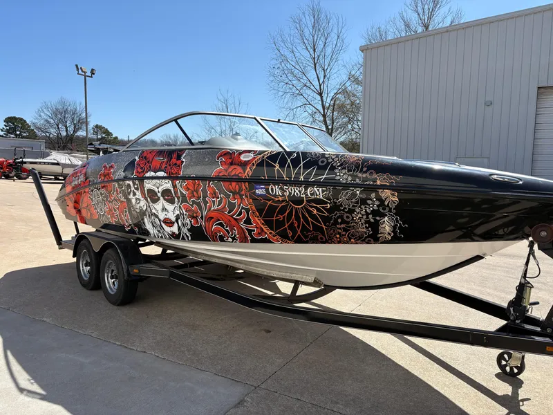 Slide: The Image of 2005 Yamaha Boats 230 SX with custom artistic exterior design on a trailer. - 4