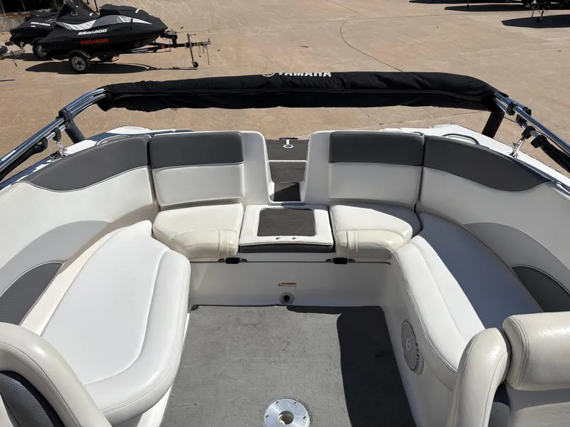 Slide: The Image of 2005 Yamaha Boats 230 SX interior with white seating and gray accents. - 7