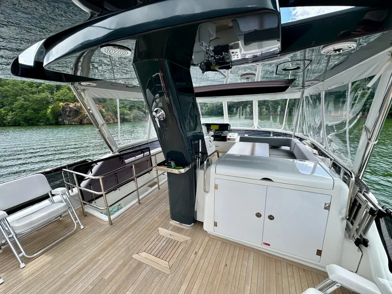 Slide: The Image of Luxurious 2021 Sirena 58 yacht interior with sleek design and spacious deck on a serene lake. - 17