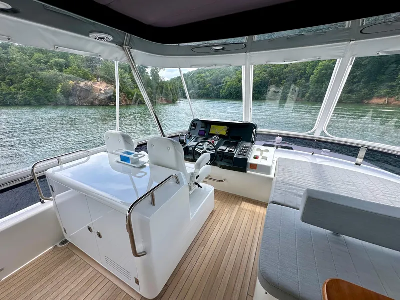 Slide: The Image of Luxurious 2021 Sirena 58 yacht interior with helm, seating, and scenic water view. - 20