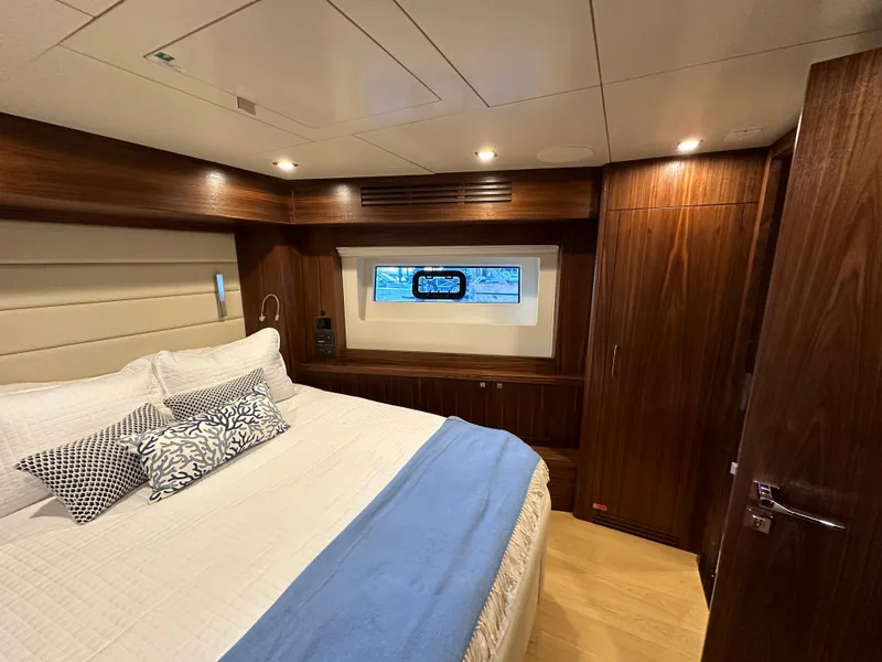 Slide: The Image of Luxurious cabin interior of 2021 Sirena 58 yacht with elegant wood finish and cozy bedding. - 38