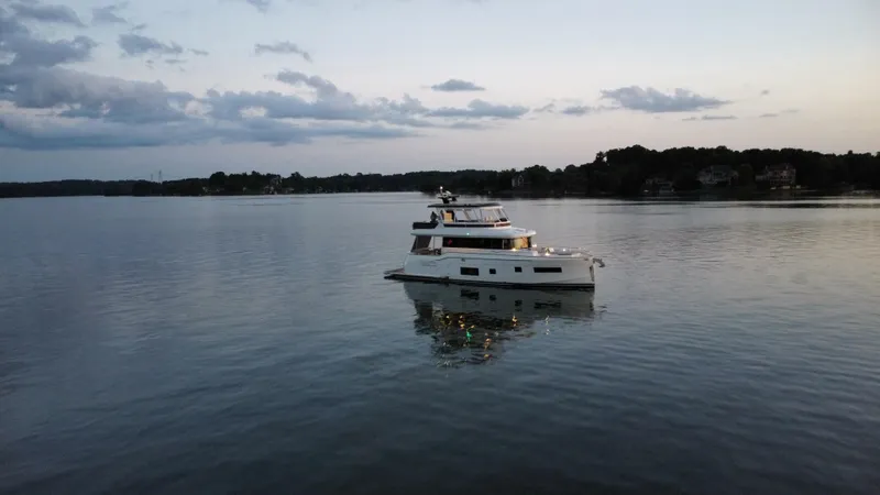 Slide: The Image of Sirena 58 yacht on calm waters at sunset, 2021 model. - 4