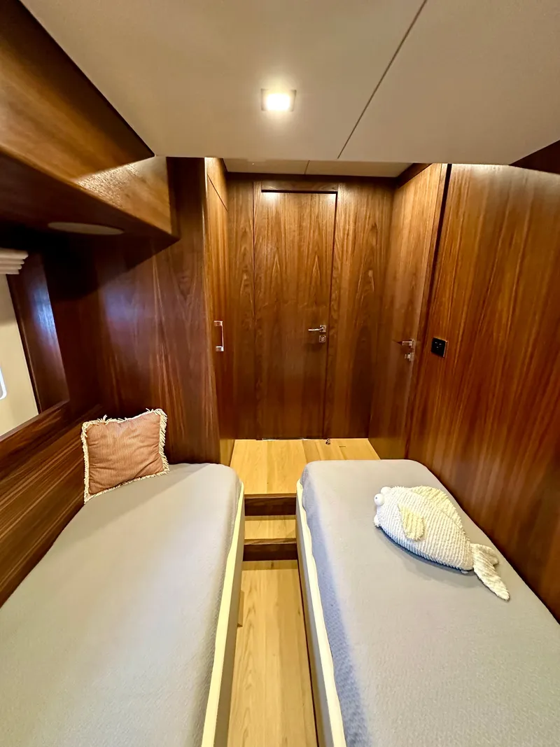 Slide: The Image of Interior of 2021 Sirena 58 yacht with twin beds and wooden paneling. - 49