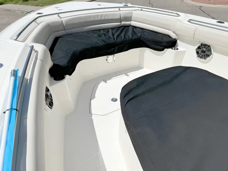 Slide: The Image of 2024 Boston Whaler 330 Outrage boat interior with cushioned seating and speakers. - 15