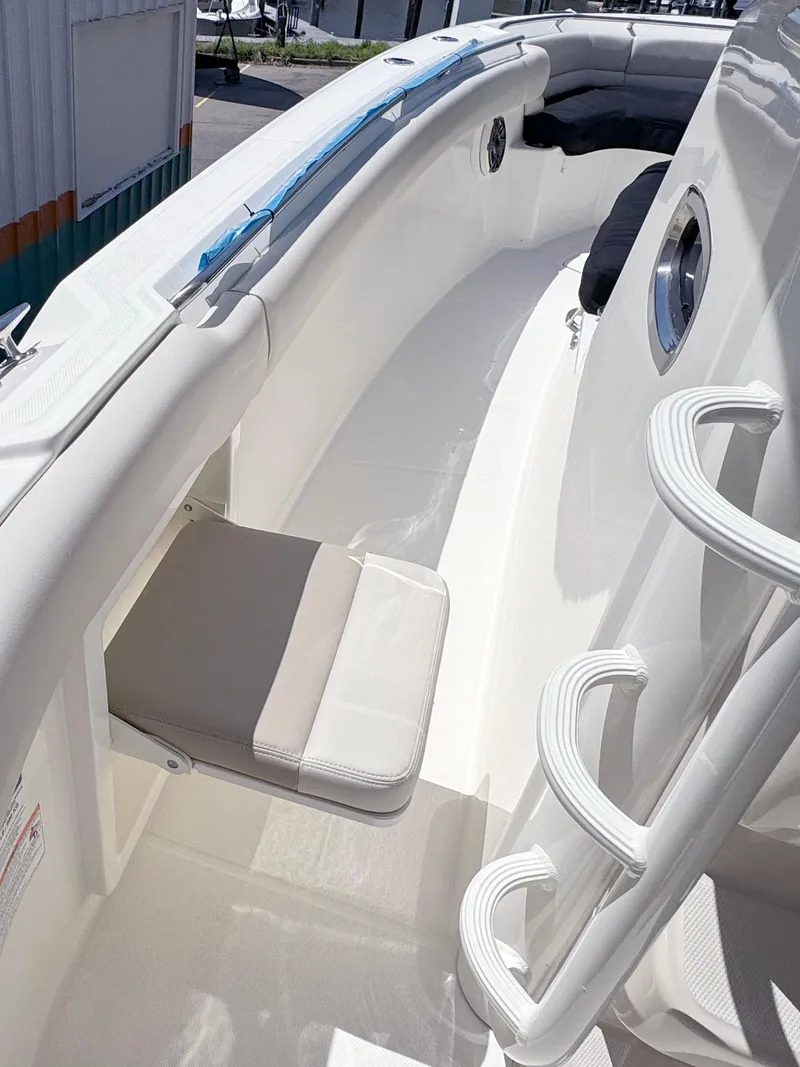 Slide: The Image of 2024 Boston Whaler 330 Outrage boat interior with seating and ladder. - 20