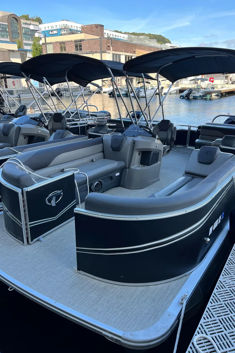 Slide: The Image of 2023 Tahoe Pontoon LTZ Cruise boat docked at a marina, featuring sleek design and spacious seating. - 11