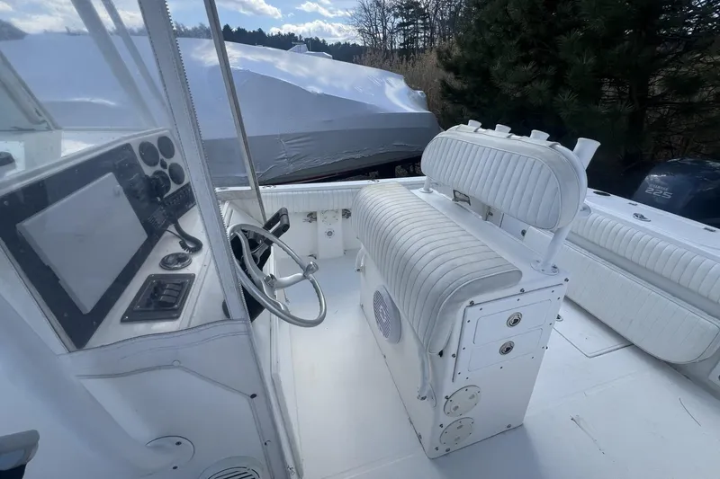 Slide: The Image of 2004 Regulator 26FS boat interior with steering wheel and cushioned seating. - 10