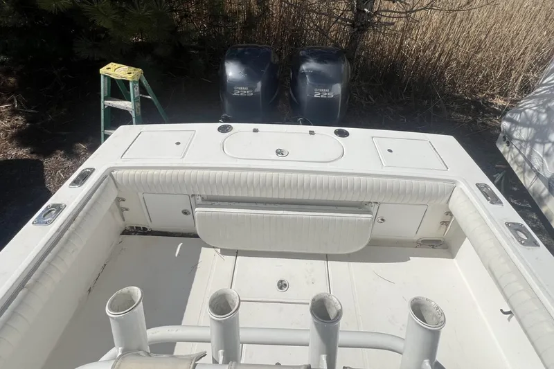 Slide: The Image of 2004 Regulator 26FS boat with twin engines and fishing rod holders. - 12