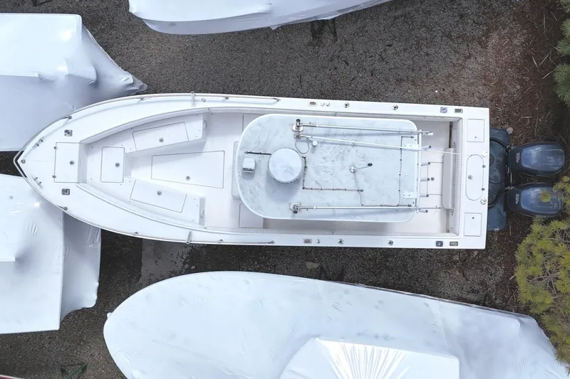 Slide: The Image of Aerial view of 2004 Regulator 26FS boat surrounded by covered vessels. - 4