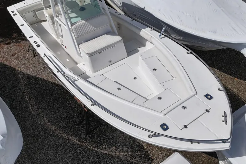 Slide: The Image of 2004 Regulator 26FS boat, white exterior, aerial view, docked on gravel. - 5