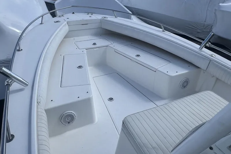 Slide: The Image of 2004 Regulator 26FS boat interior with white seating and storage compartments. - 9