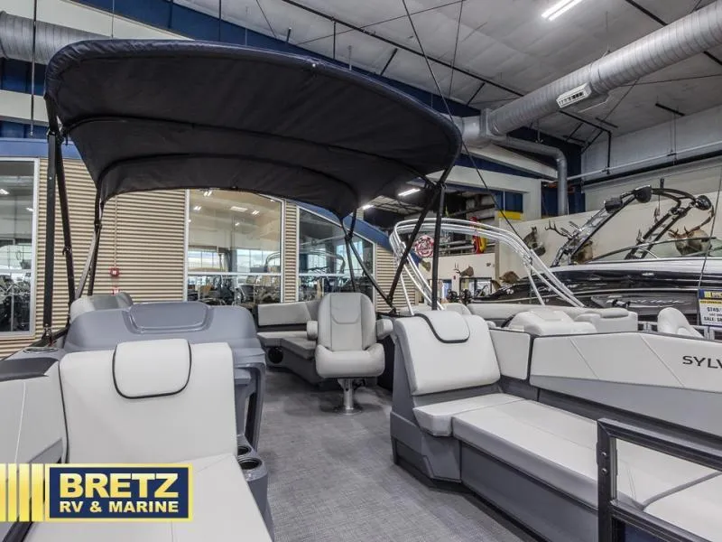 Slide: The Image of Modern 2025 A-Series A20 LZ DH pontoon boat interior at Bretz RV & Marine showroom. - 10