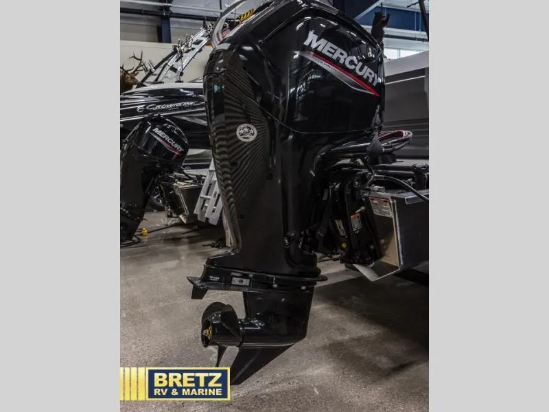 Slide: The Image of Outboard motor on display at Bretz RV & Marine showroom, featuring Mercury branding. - 8