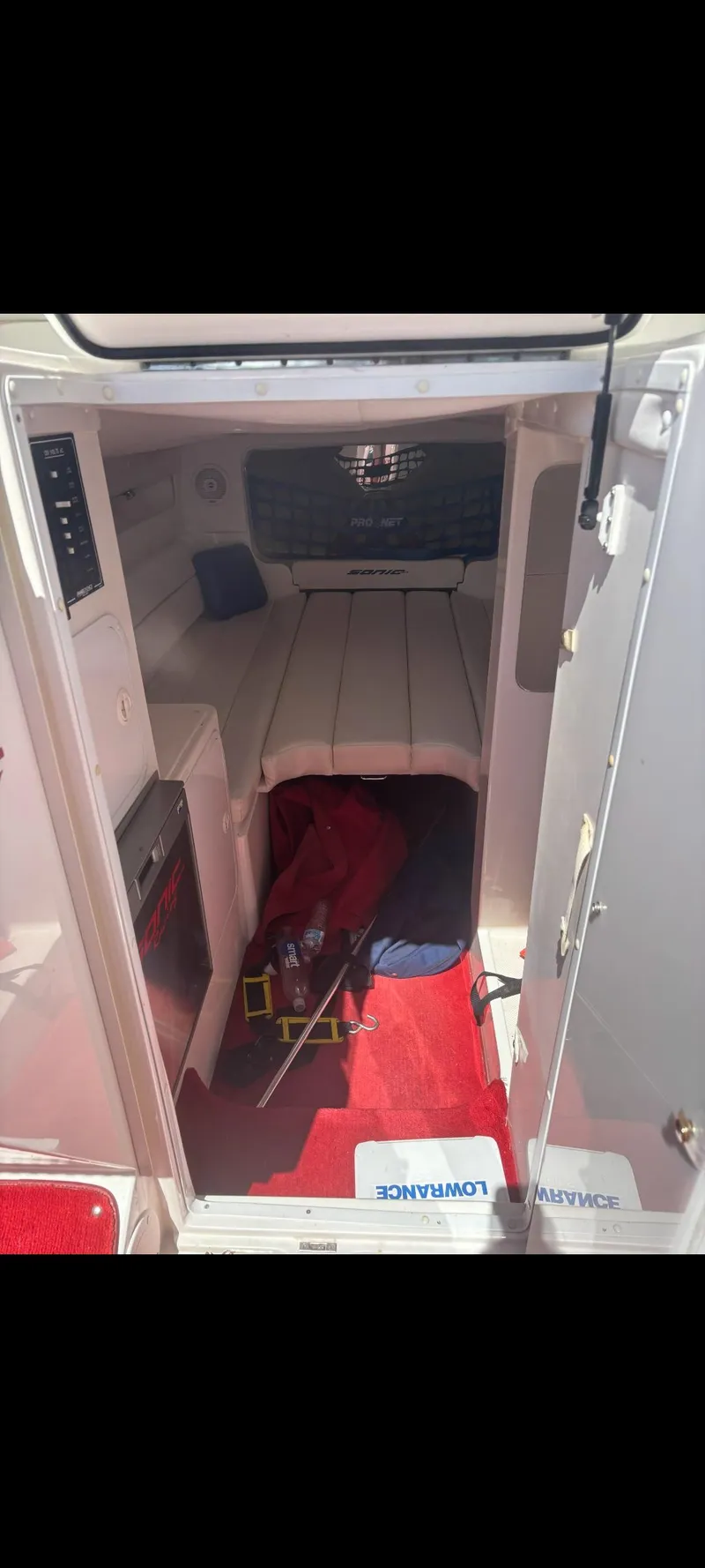 Slide: The Image of 2001 Sonic 31 SS boat cabin interior with red carpet and white seating. - 10