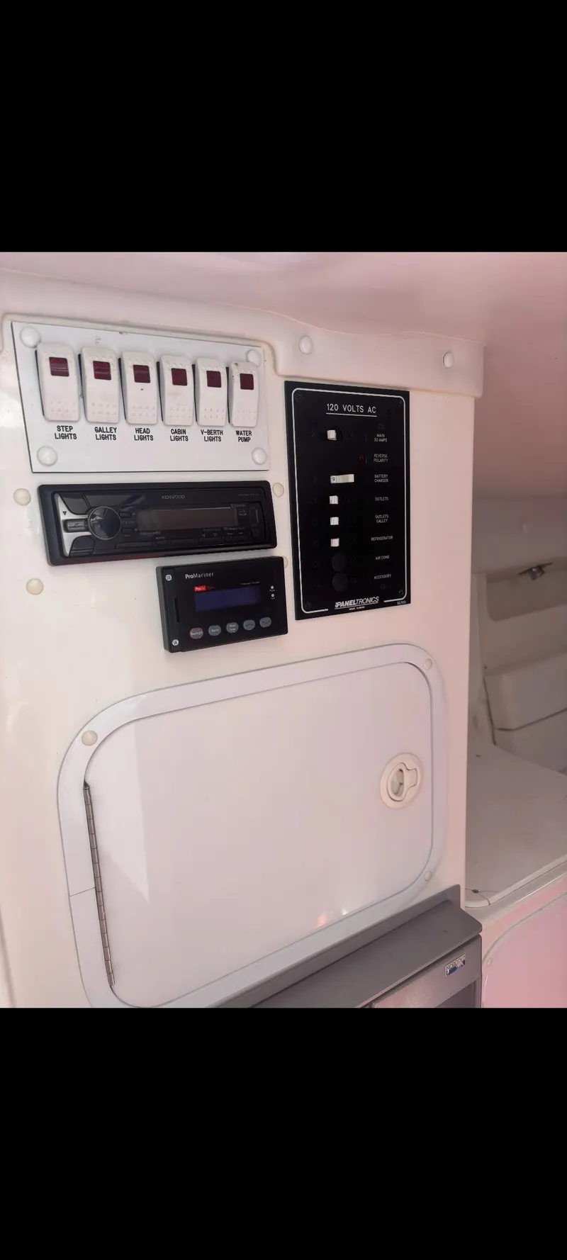 Slide: The Image of Control panel inside a 2001 Sonic 31 SS boat, featuring switches and gauges. - 11