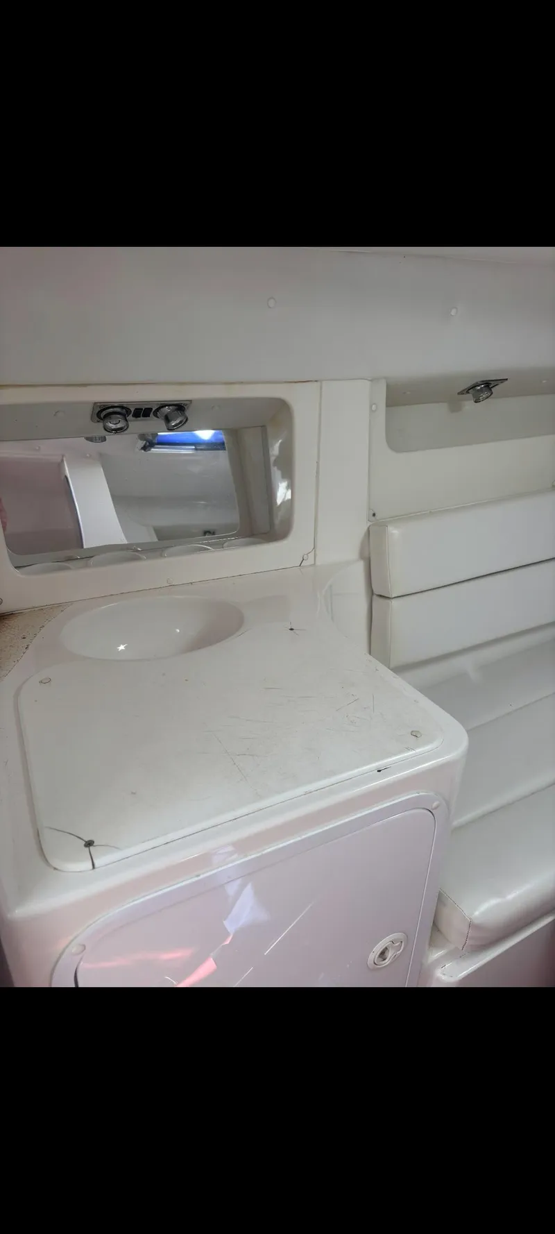 Slide: The Image of 2001 Sonic 31 SS boat interior with sink and mirror. - 13