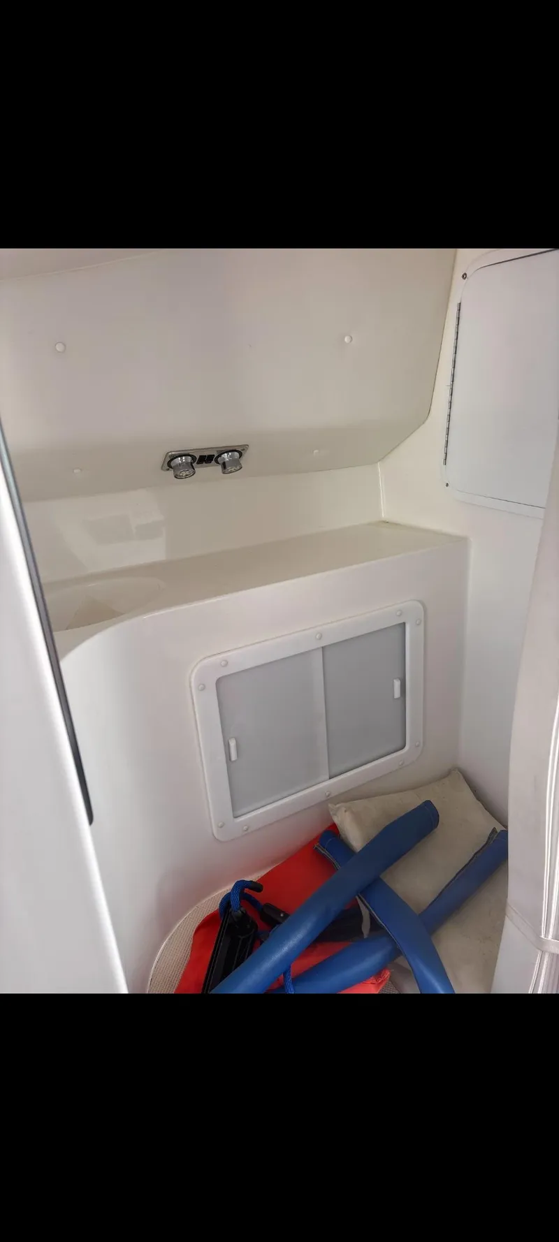 Slide: The Image of Interior cabin of 2001 Sonic 31 SS boat with storage and life jackets. - 15