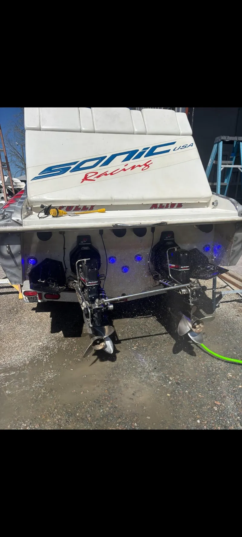 Slide: The Image of 2001 Sonic 31 SS boat with dual outboard motors and blue accent lights. - 5