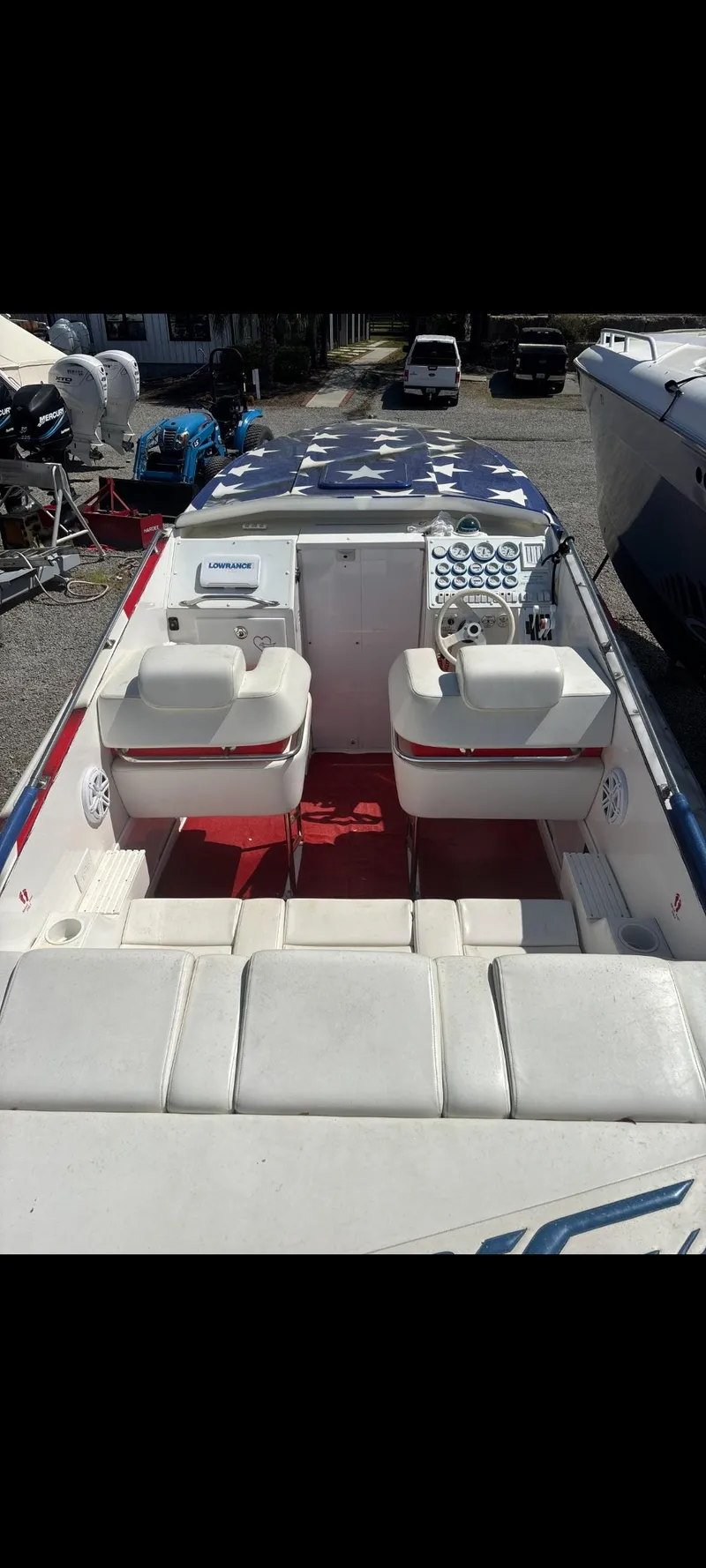 Slide: The Image of 2001 Sonic 31 SS boat with white seating and red flooring, docked outdoors. - 6