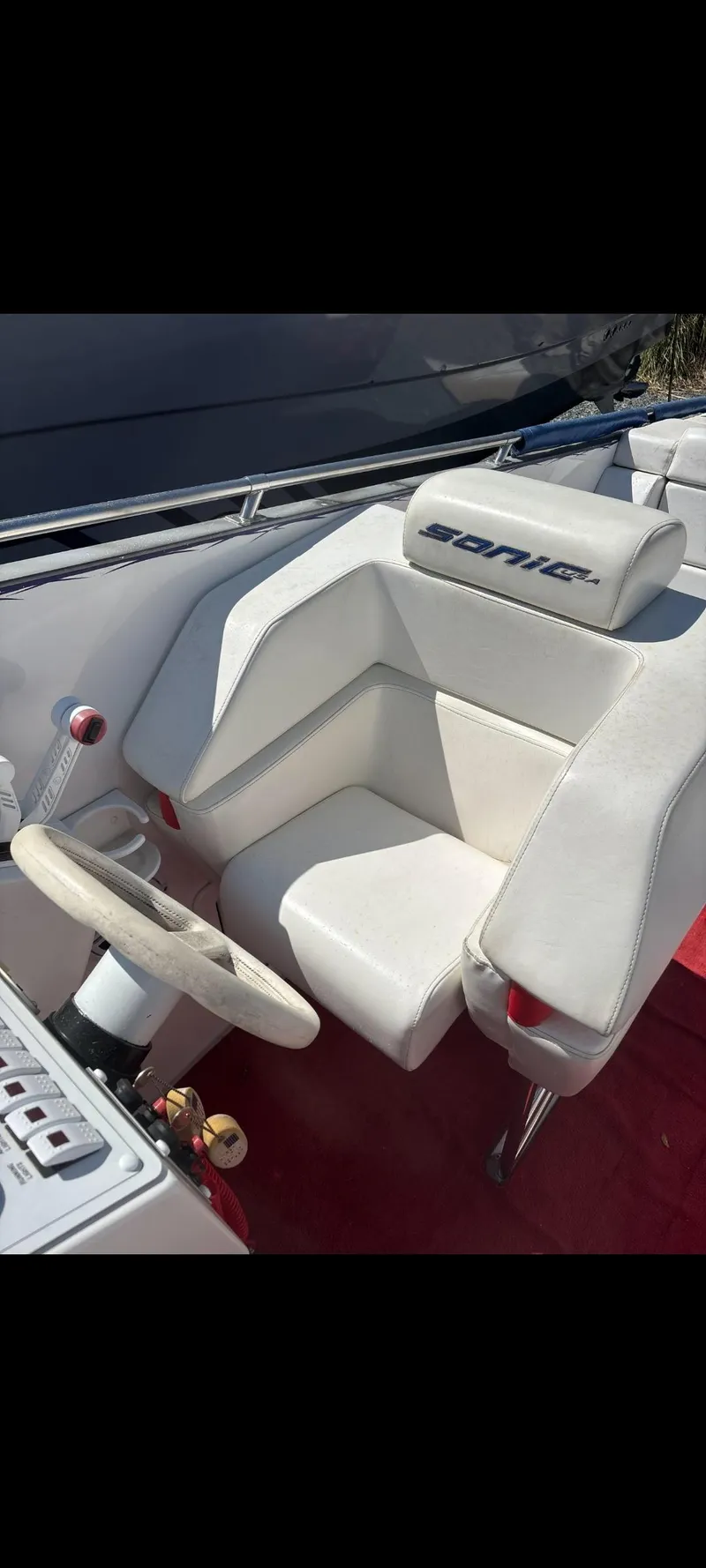 Slide: The Image of 2001 Sonic 31 SS boat cockpit with white seating and steering wheel. - 8