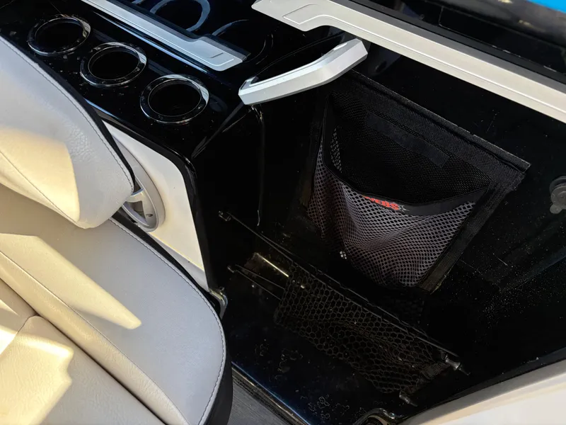 Slide: The Image of Interior of 2019 Yamaha Boats 242X E-Series, featuring seating and storage compartments. - 11