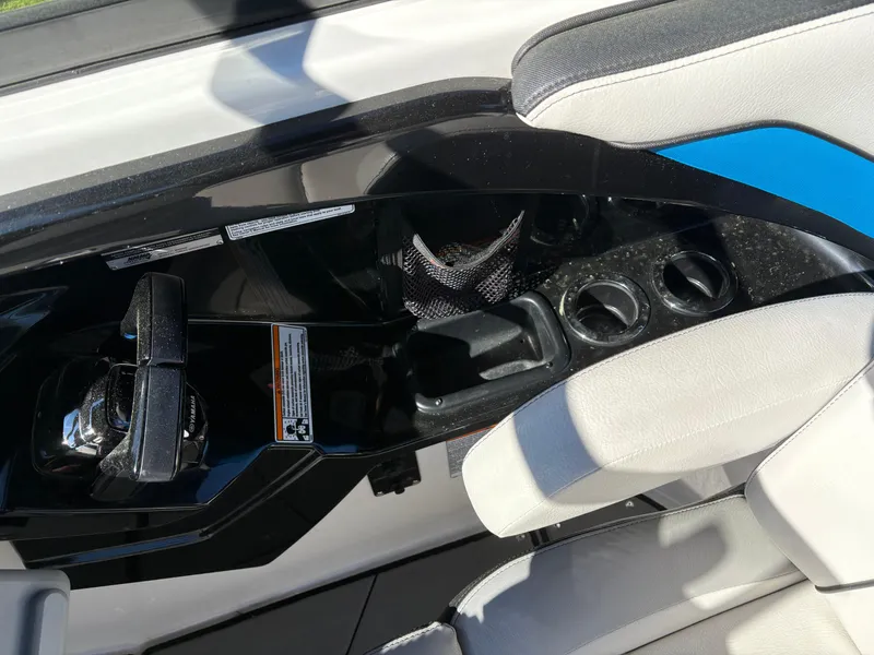 Slide: The Image of 2019 Yamaha Boats 242X E-Series interior with cup holders and seating. - 13