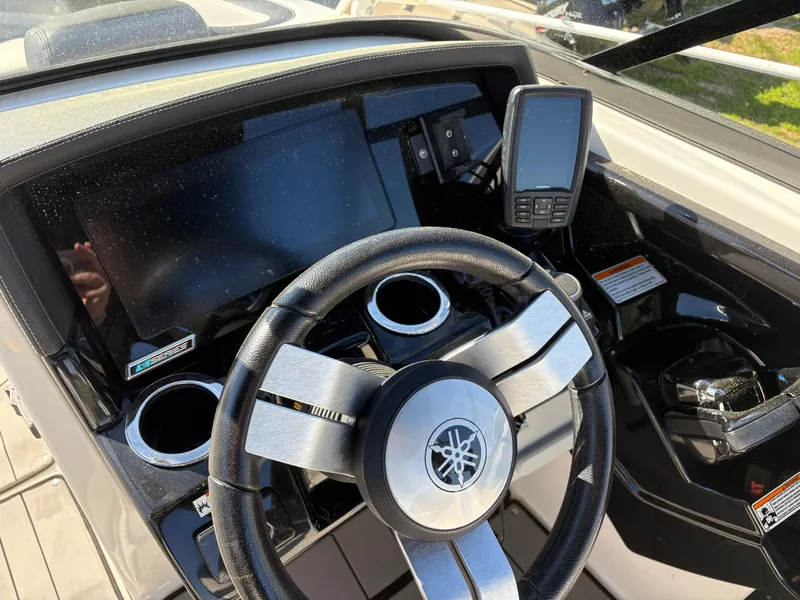 Slide: The Image of 2019 Yamaha Boats 242X E-Series dashboard with steering wheel and digital display. - 14
