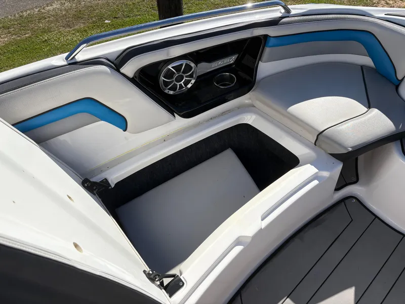 Slide: The Image of 2019 Yamaha Boats 242X E-Series interior with seating, speaker, and storage compartment. - 23
