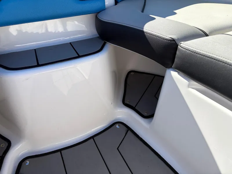 Slide: The Image of 2019 Yamaha Boats 242X E-Series interior seating with blue and gray upholstery. - 24