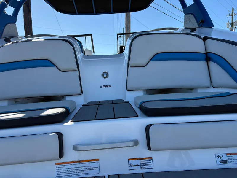 Slide: The Image of 2019 Yamaha Boats 242X E-Series interior with cushioned seating and sleek design. - 4