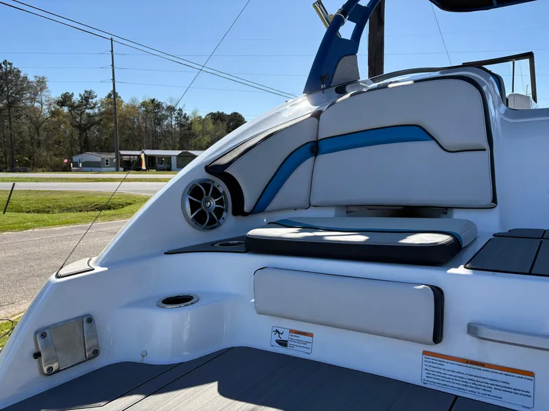 Slide: The Image of 2019 Yamaha Boats 242X E-Series interior with sleek seating and speaker system. - 5