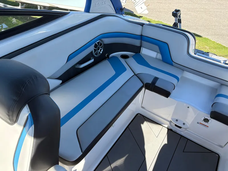 Slide: The Image of 2019 Yamaha Boats 242X E-Series interior with blue and white seating and speaker system. - 7