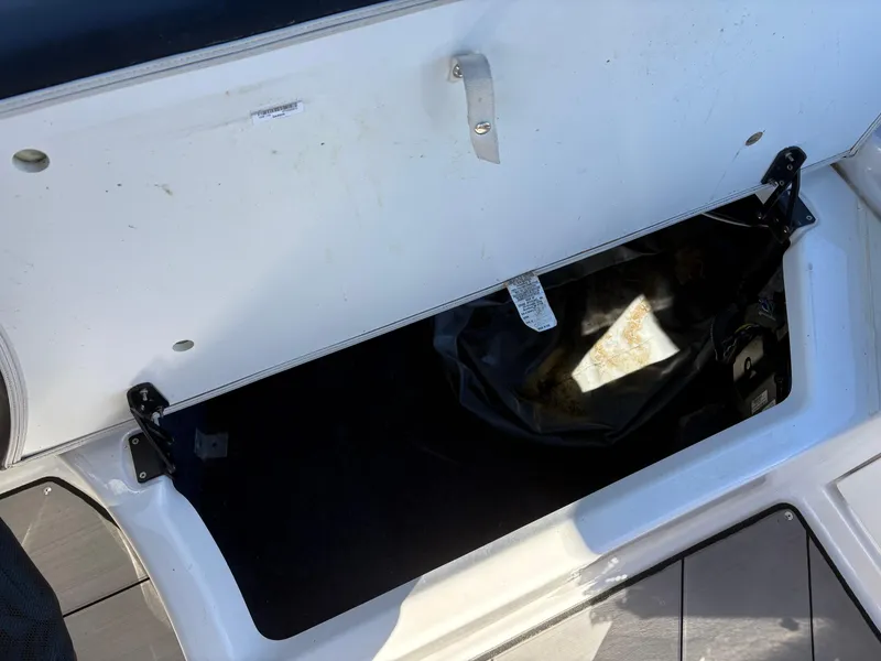 Slide: The Image of Open storage compartment on a 2019 Yamaha Boats 242X E-Series. - 8