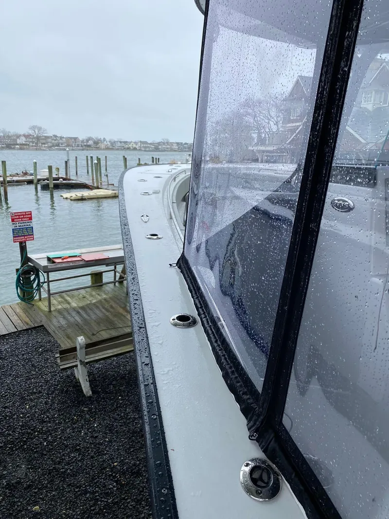 Slide: The Image of 2022 Cape Horn 36 XS boat docked on a rainy day by the waterfront. - 11