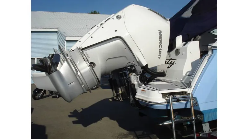 Slide: The Image of 2022 Blackfin 272 DC boat with Mercury outboard motor, docked outdoors. - 1