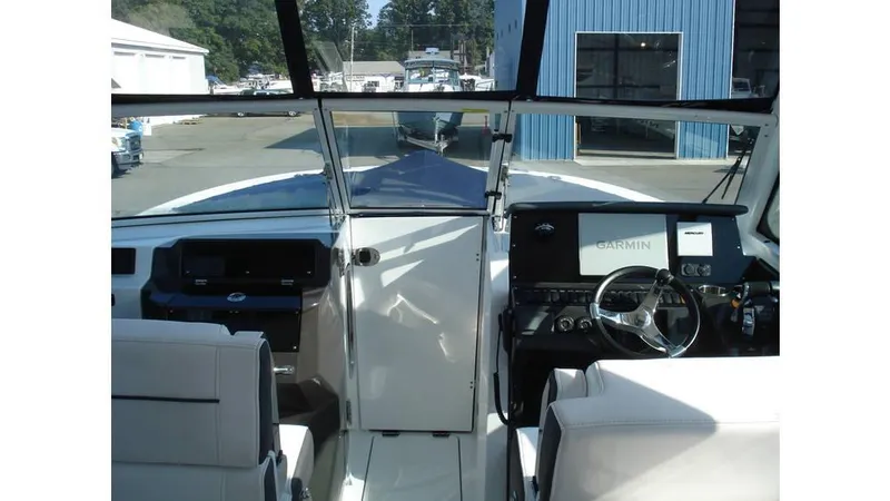 Slide: The Image of 2022 Blackfin 272 DC boat interior with steering wheel and Garmin navigation system. - 10