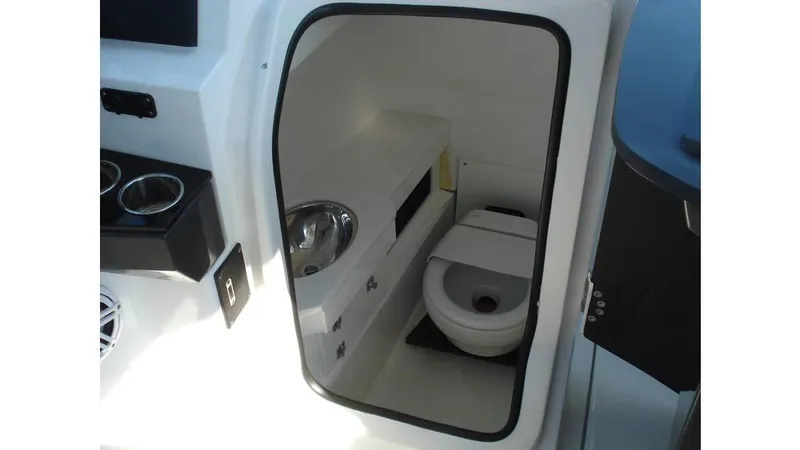 Slide: The Image of 2022 Blackfin 272 DC boat interior with compact bathroom and toilet. - 11