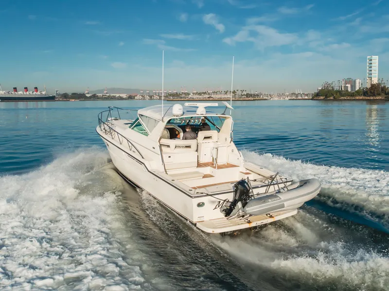 Slide: The Image of 1996 Tiara Yachts 4300 cruising on a sunny day, leaving a wake behind. - 15