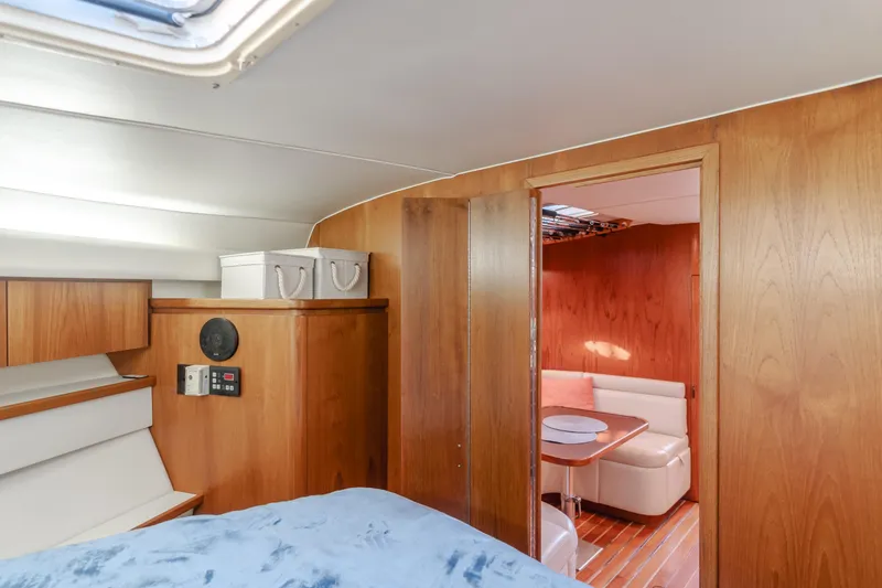 Slide: The Image of 1996 Tiara Yachts 4300 interior with wood paneling and cozy seating area. - 22