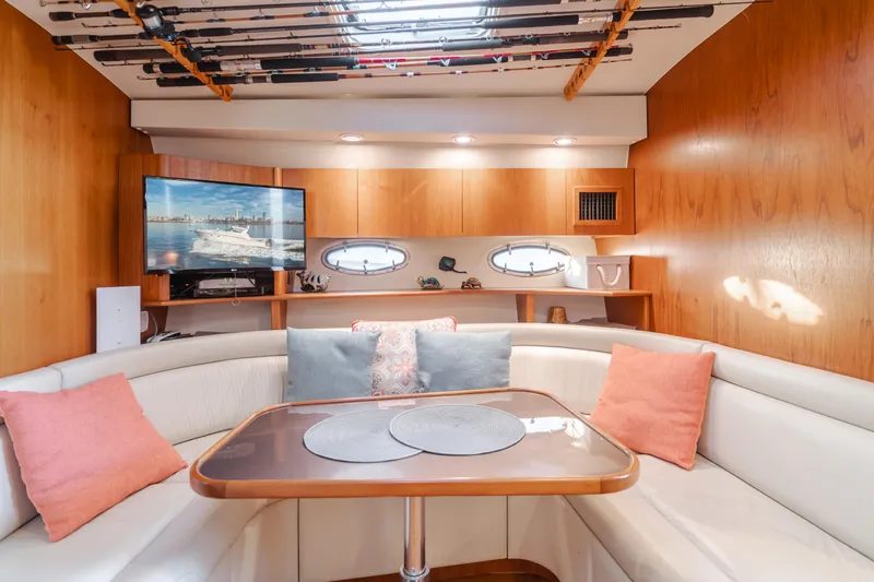 Slide: The Image of Luxurious 1996 Tiara Yachts 4300 interior with cozy seating and elegant wooden finishes. - 23