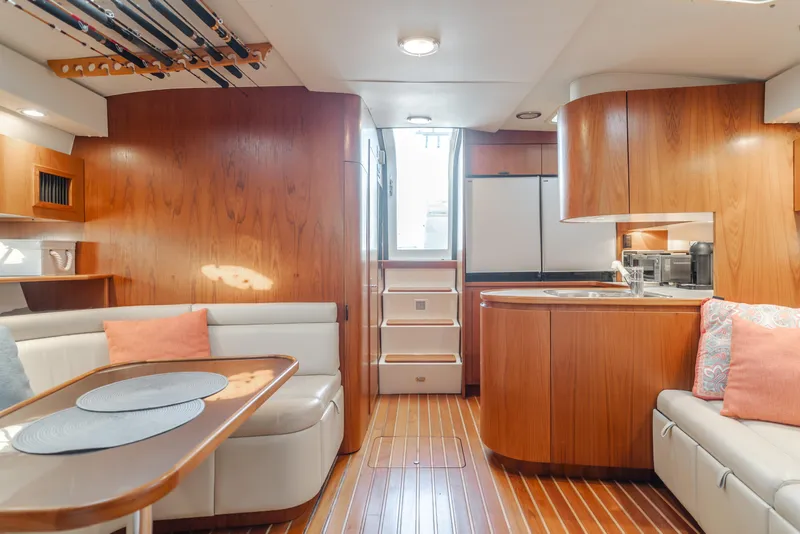Slide: The Image of Interior of a 1996 Tiara Yachts 4300, featuring wood finishes and cozy seating. - 29