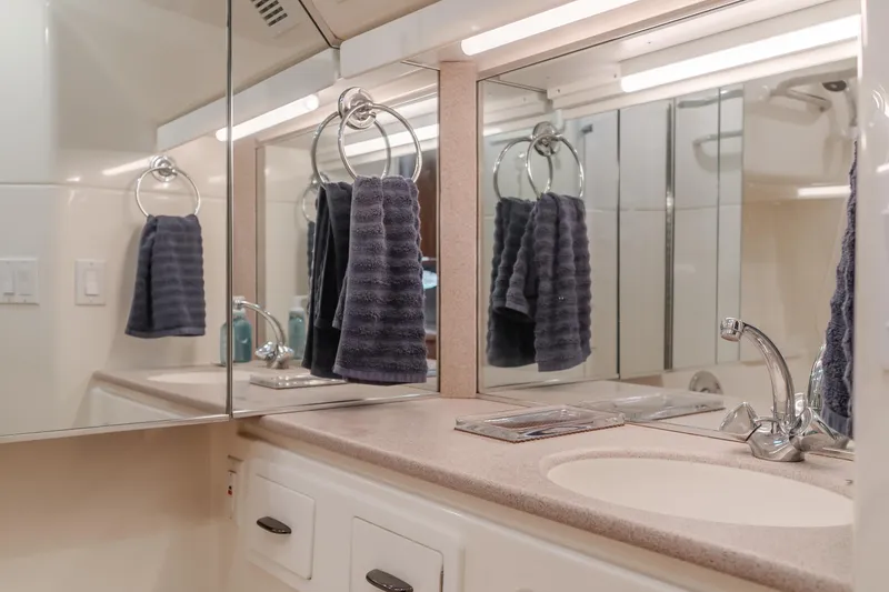 Slide: The Image of Luxurious bathroom in 1996 Tiara Yachts 4300, featuring elegant fixtures and mirrored cabinets. - 30