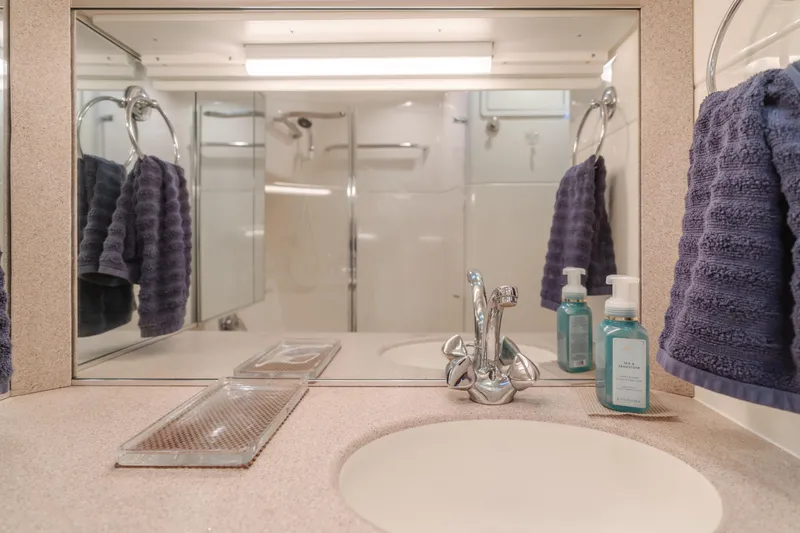 Slide: The Image of Bathroom interior of 1996 Tiara Yachts 4300 with sink, mirror, and towels. - 31