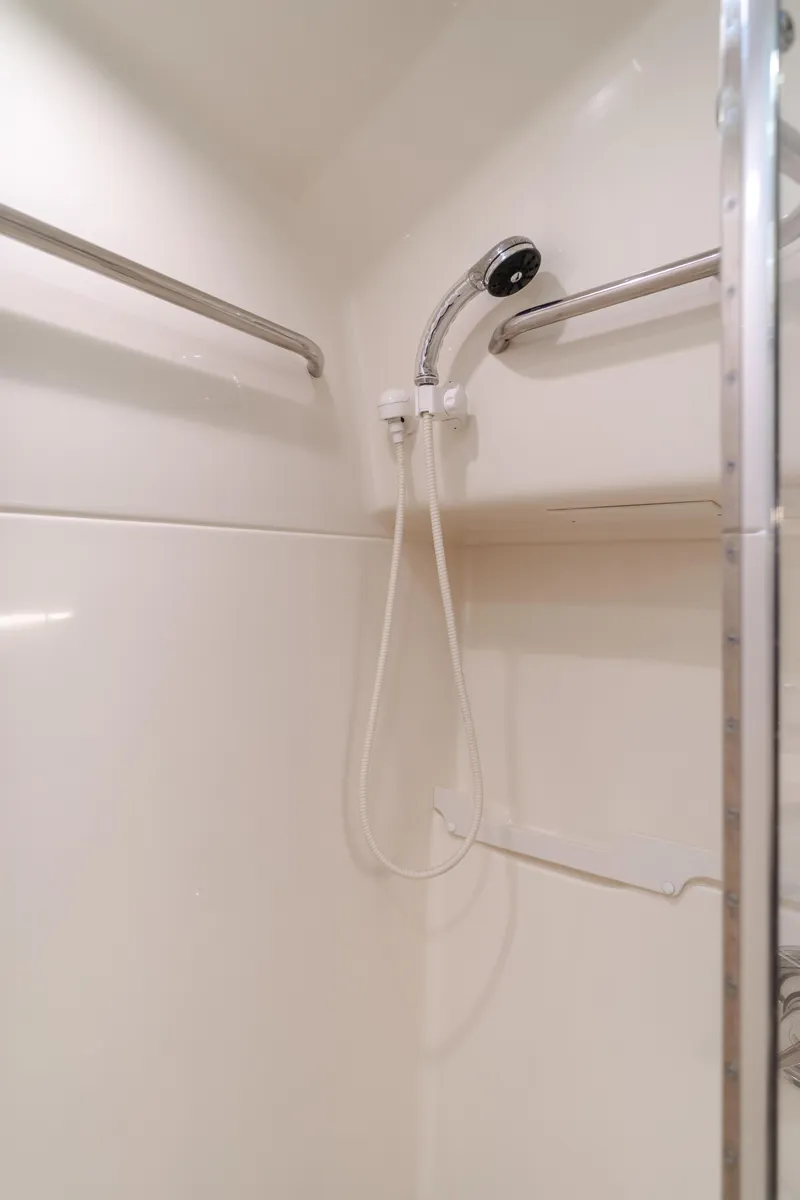 Slide: The Image of Shower area in 1996 Tiara Yachts 4300, featuring a handheld showerhead and sleek design. - 32