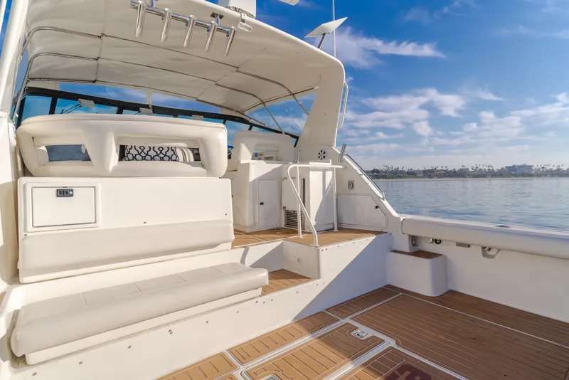 Slide: The Image of 1996 Tiara Yachts 4300 with spacious deck, white seating, and scenic water view. - 33