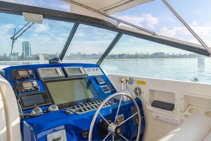 Slide: The Image of Helm of 1996 Tiara Yachts 4300, featuring modern navigation equipment and scenic ocean view. - 41