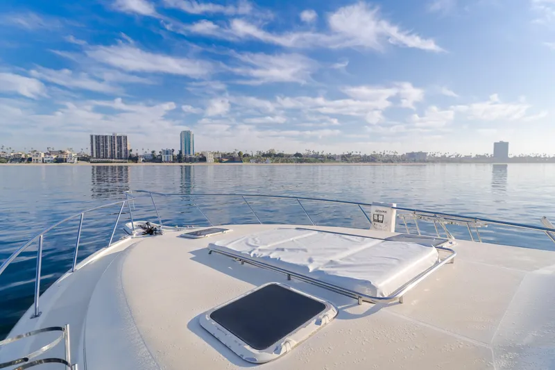 Slide: The Image of Tiara Yachts 4300, 1996 model, cruising on calm waters with city skyline view. - 42